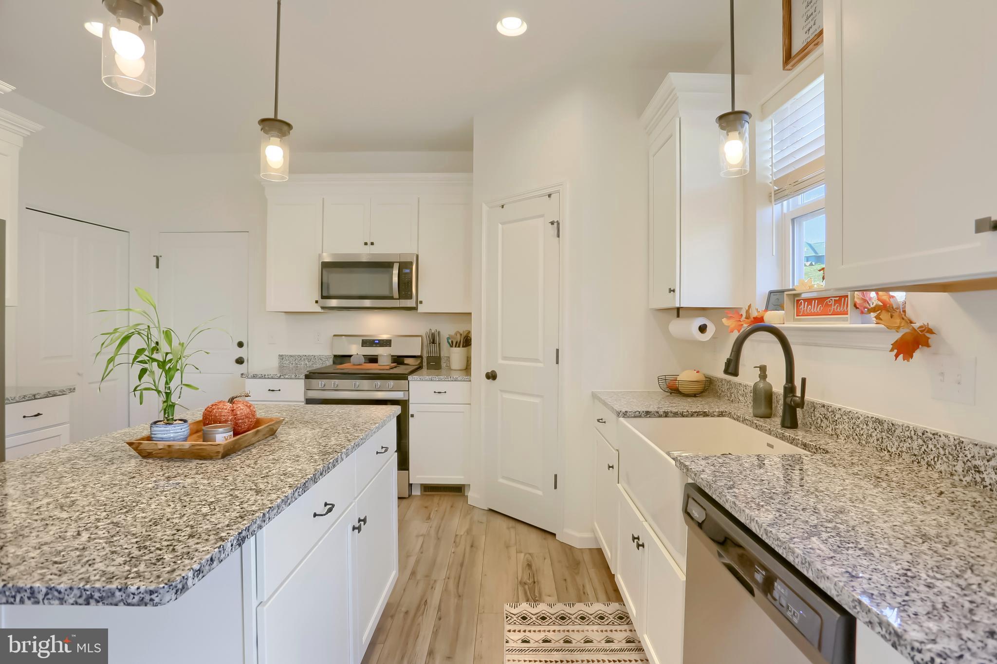 509 Elm Street Harrisburg, PA 17112 - Photo 12 of 41 a kitchen with granite countertop a sink stove and cabinets