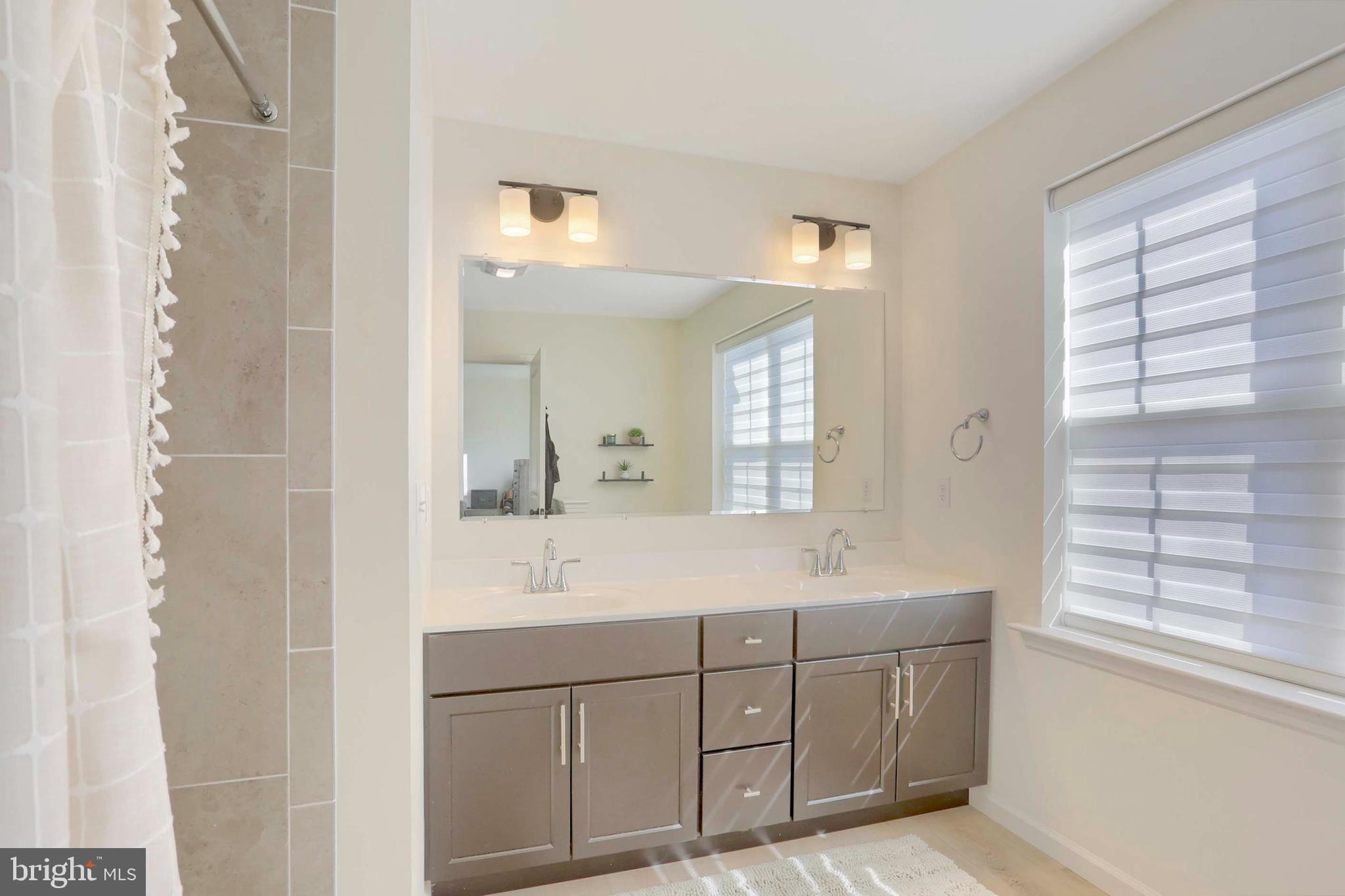 509 Elm Street Harrisburg, PA 17112 - Photo 24 of 41 a bathroom with a sink shower and a mirror