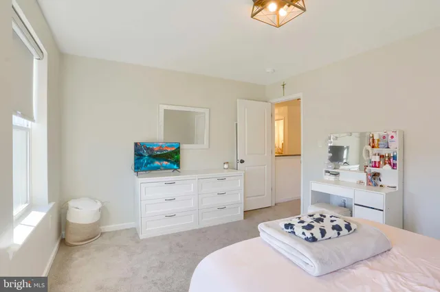 a bedroom with bed and a window