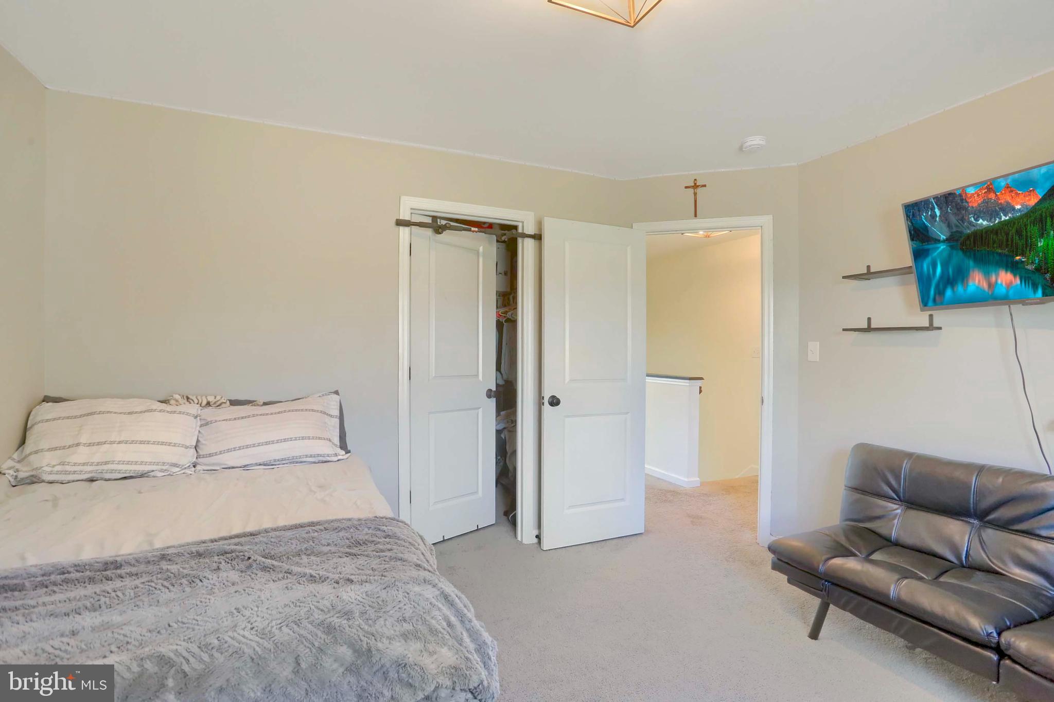 509 Elm Street Harrisburg, PA 17112 - Photo 30 of 41 a bedroom with a bed and a couch