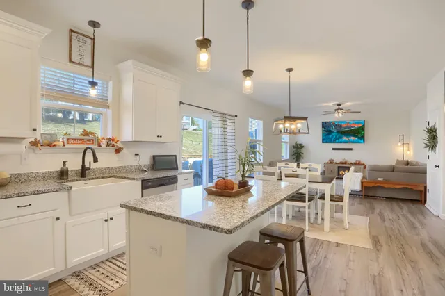 a kitchen with granite countertop a sink stove and cabinets