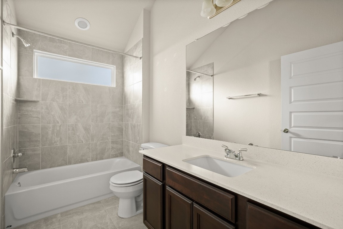 5601 Respinto Drive Austin, TX 78747 - Photo 14 of 17 a bathroom with a sink a toilet and shower