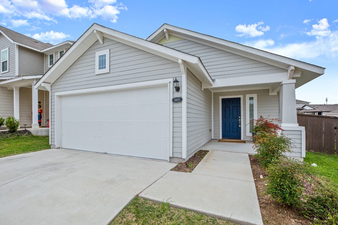 5601 Respinto Drive Austin, TX 78747 - Photo 2 of 17 a view of a house with a yard and garage