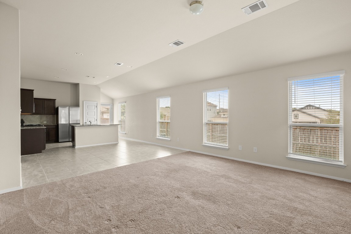 5601 Respinto Drive Austin, TX 78747 - Photo 5 of 17 a view of an empty room with a window and a kitchen