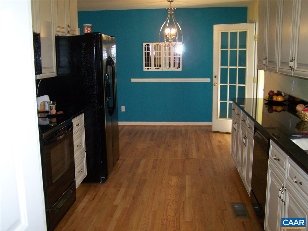 19 Deer Path Road Palmyra, VA 22963 - Photo 6 of 50 a kitchen with a wooden floor and a refrigerator