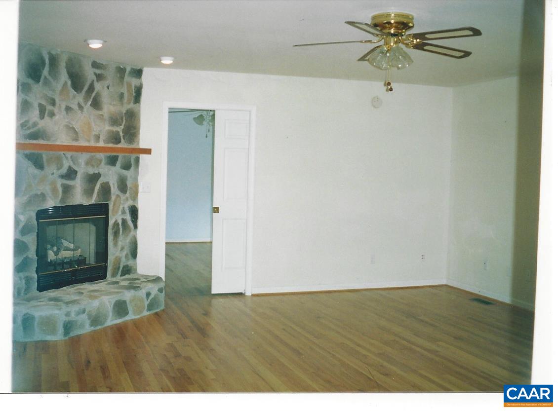 19 Deer Path Road Palmyra, VA 22963 - Photo 7 of 50 a view of an empty room with wooden floor and a window