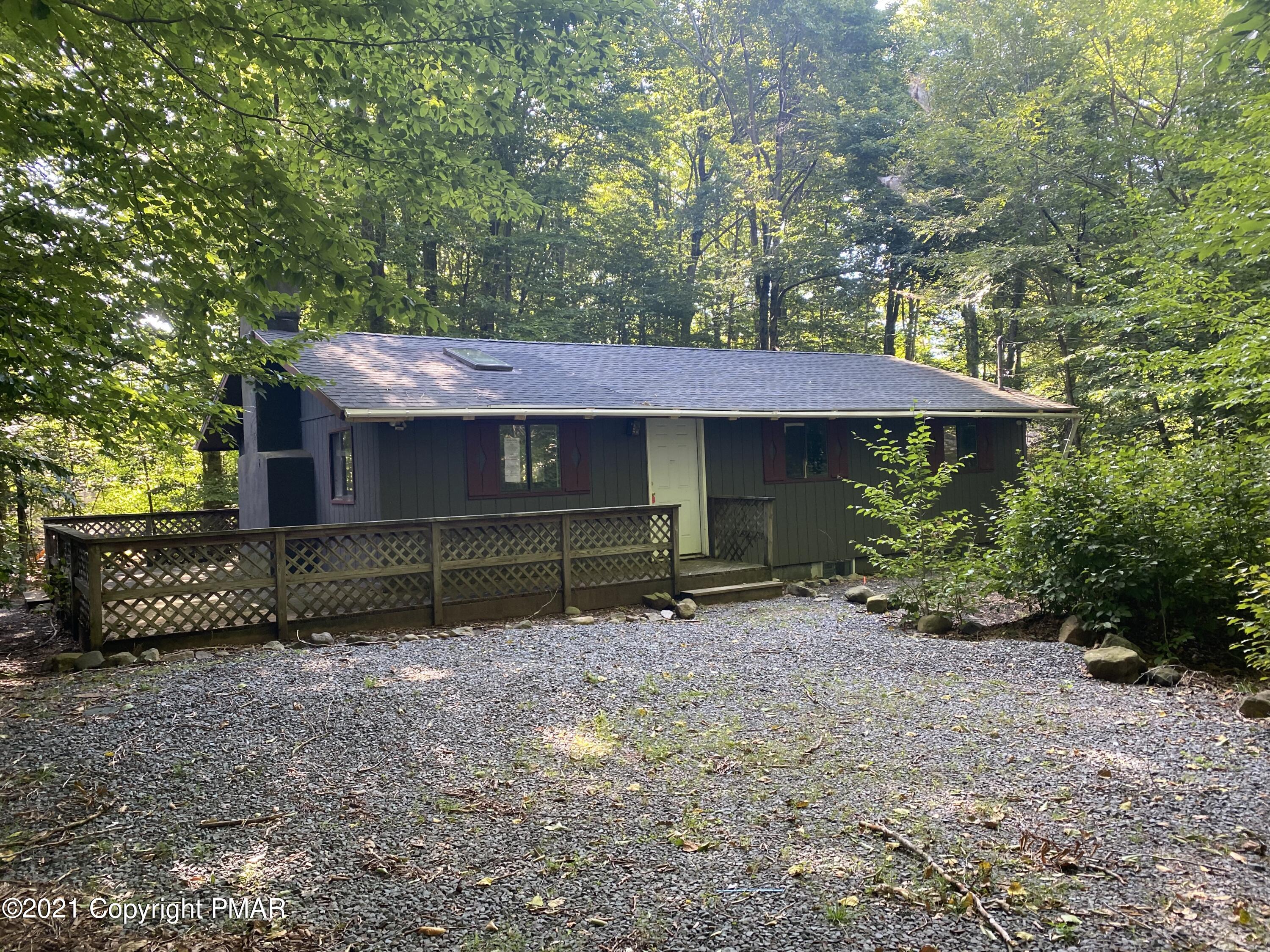 1194 Deer Run Pocono Pines, PA 18350 - Photo 1 of 14 a front view of a house with a yard