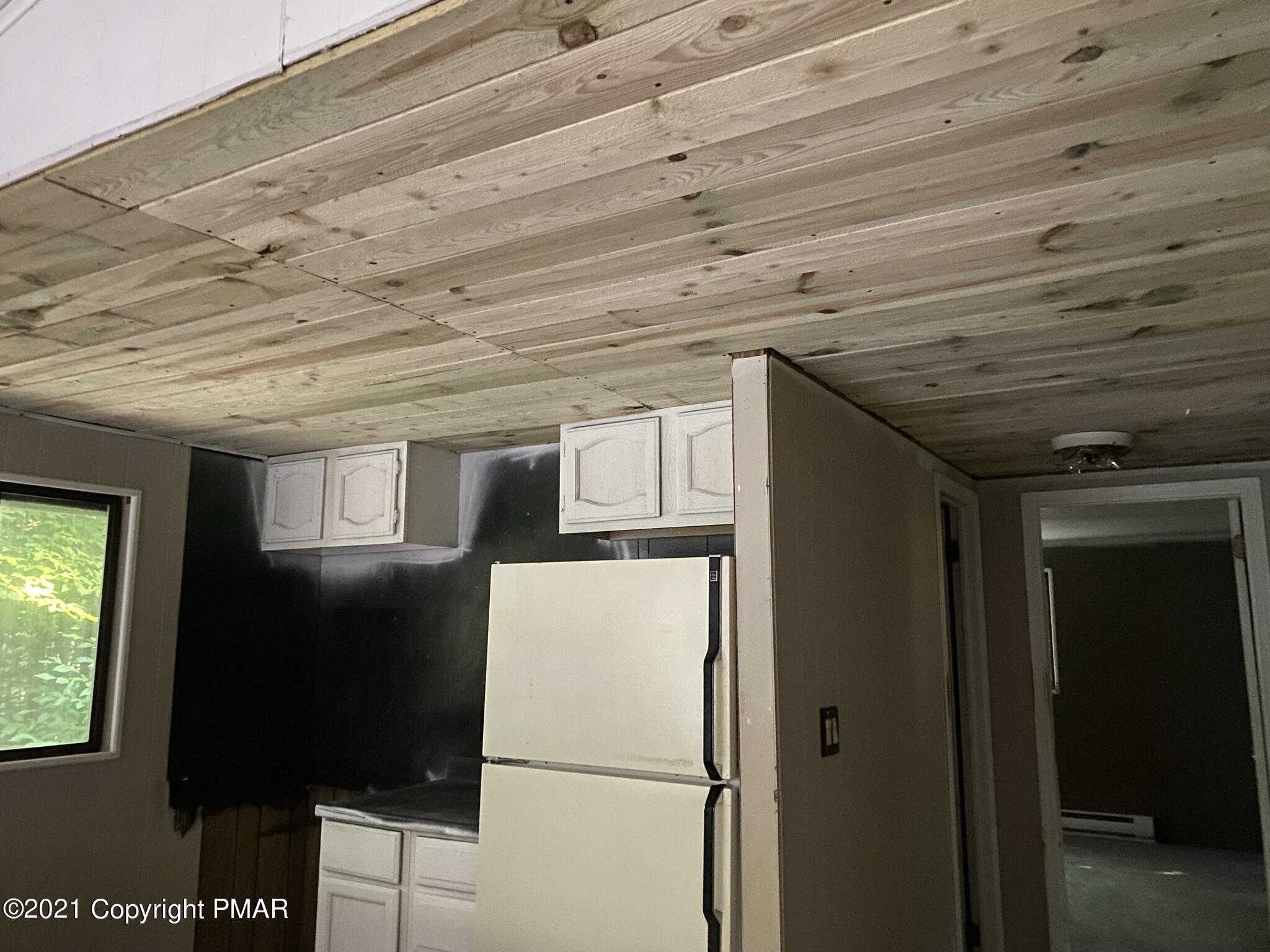 1194 Deer Run Pocono Pines, PA 18350 - Photo 12 of 14 a view of a refrigerator in kitchen and an empty room