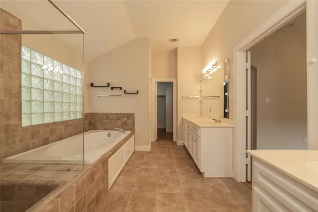 a bathroom with a bathtub and a shower