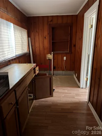 a kitchen with a wooden cabinets and washing machine