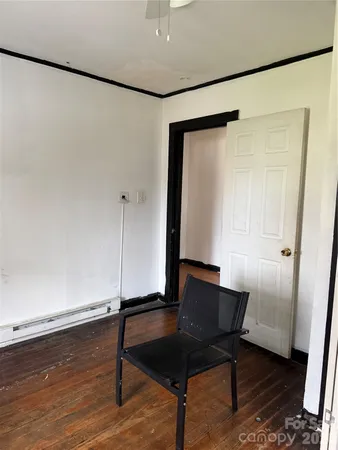 a view of a room with wooden floor and bench