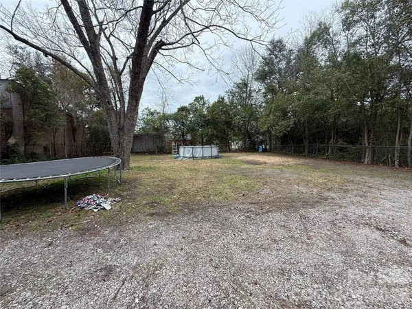 a view of a field with trees in the background