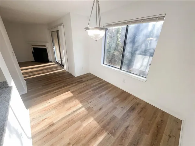 a view of a room with wooden floor and windows