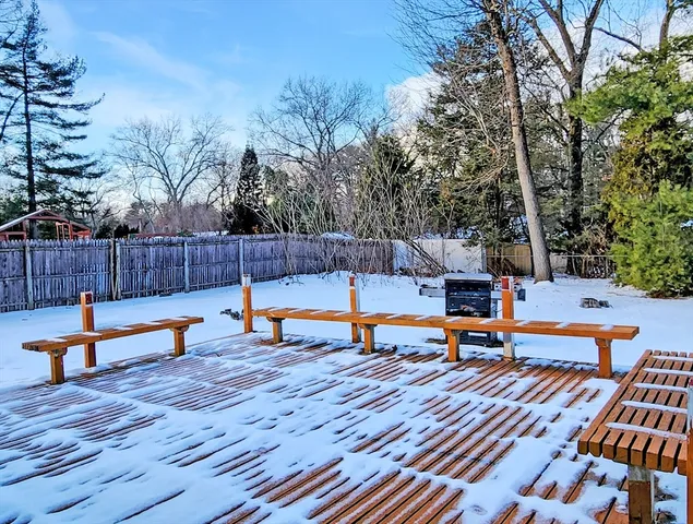 a view of a swimming pool with a bench and wooden bench