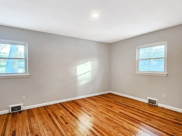 a view of a room with wooden floor and fan