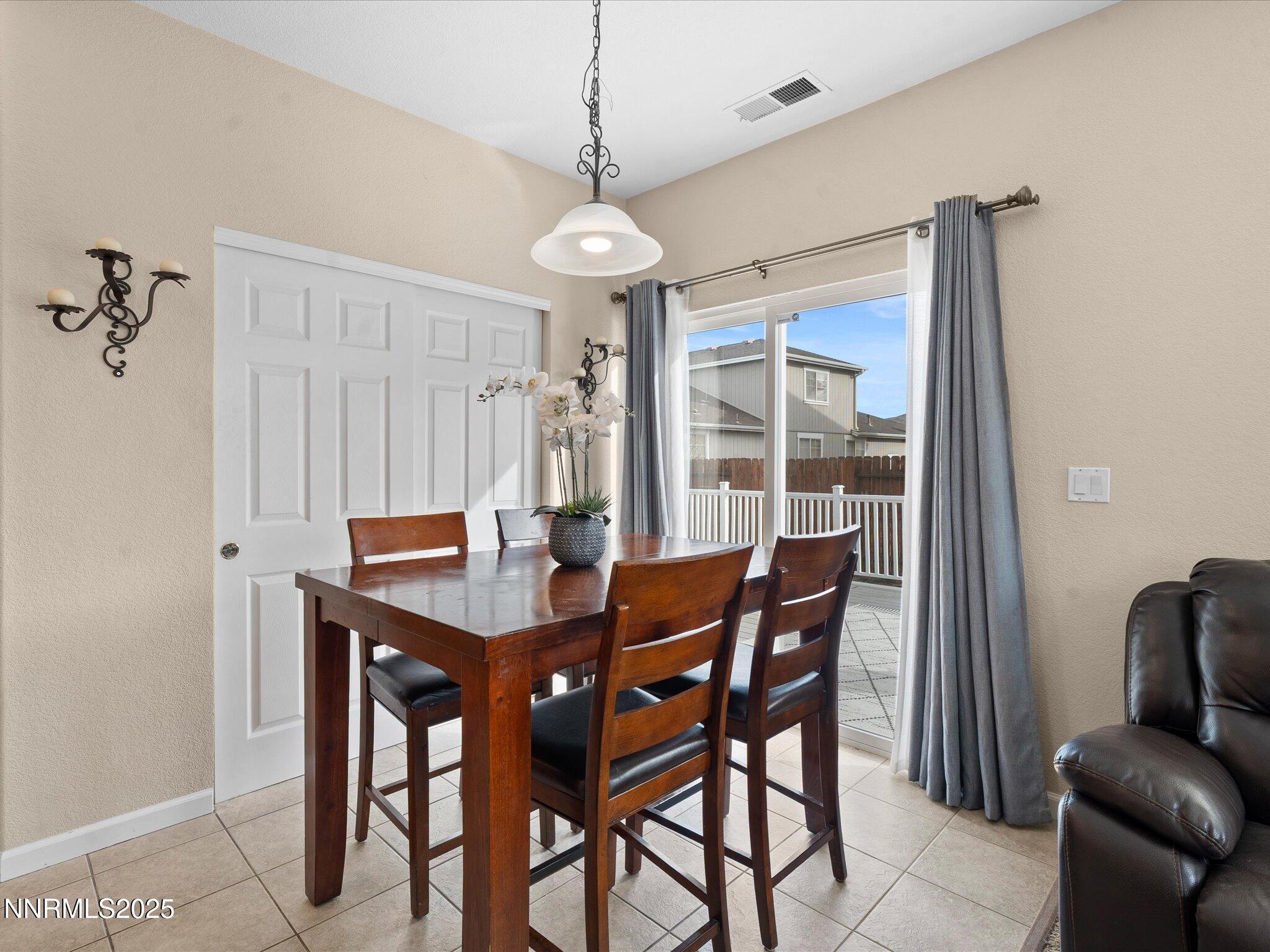 8934 Sorcha Street Reno, NV 89506 - Photo 13 of 60 a view of a dining room with furniture window and outside view