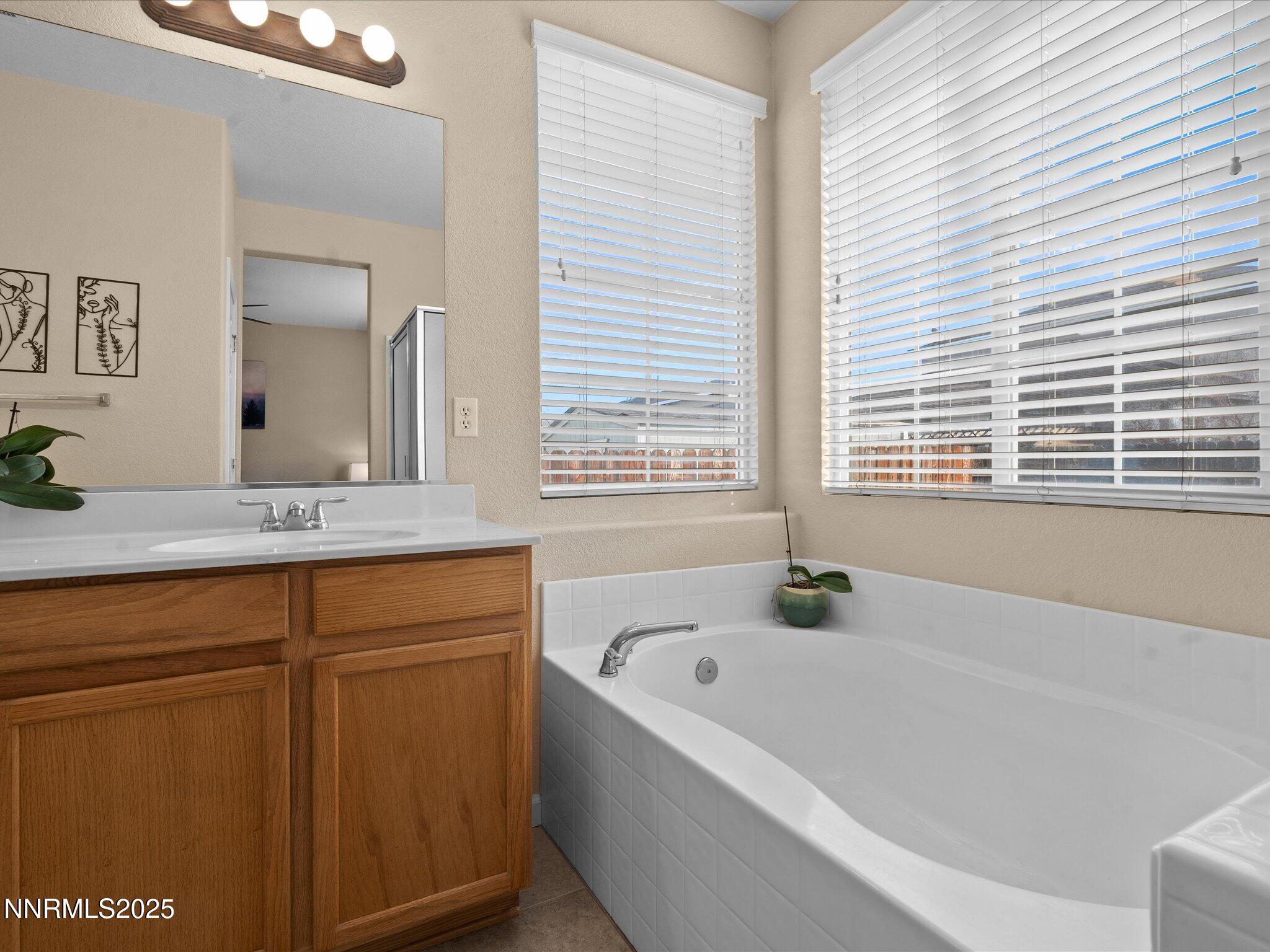 8934 Sorcha Street Reno, NV 89506 - Photo 26 of 60 a bathroom with a bathtub and a sink