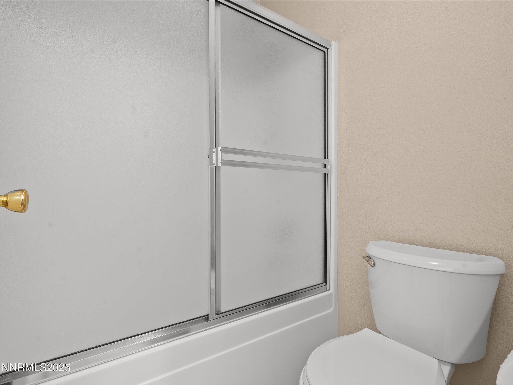 8934 Sorcha Street Reno, NV 89506 - Photo 32 of 60 a white toilet sitting next to a shower