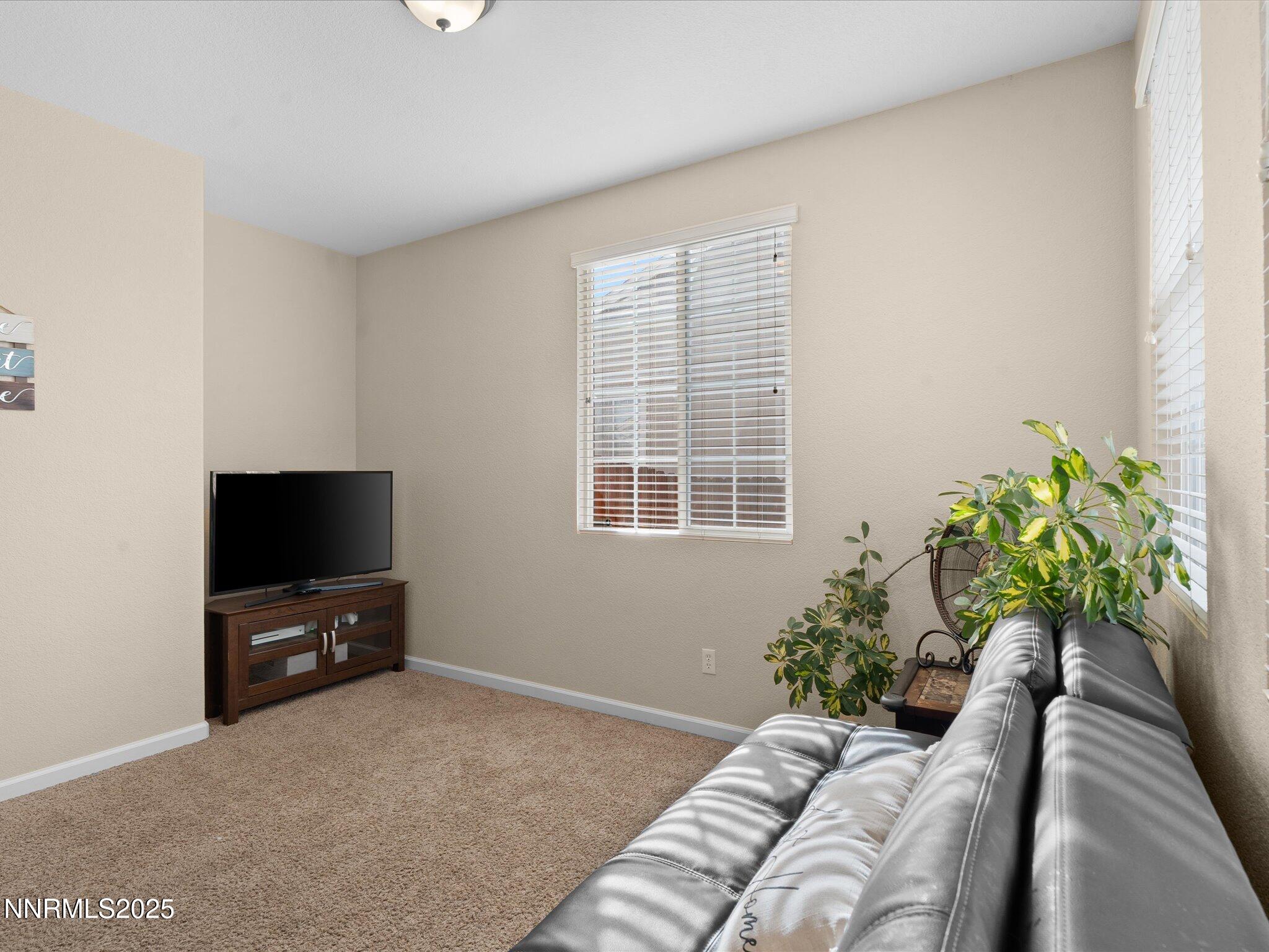 8934 Sorcha Street Reno, NV 89506 - Photo 8 of 60 a living room with furniture and a flat screen tv