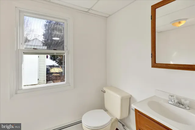 a white toilet sitting next to a bathroom sink