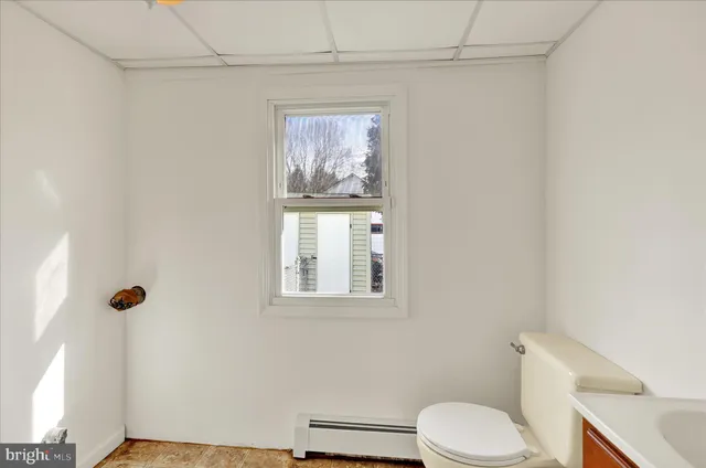 a white toilet sitting next to a bathroom sink