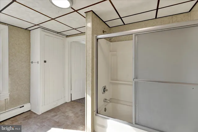 a bathroom with a glass shower door