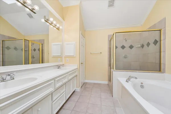 a bathroom with a tub a sink and mirrors