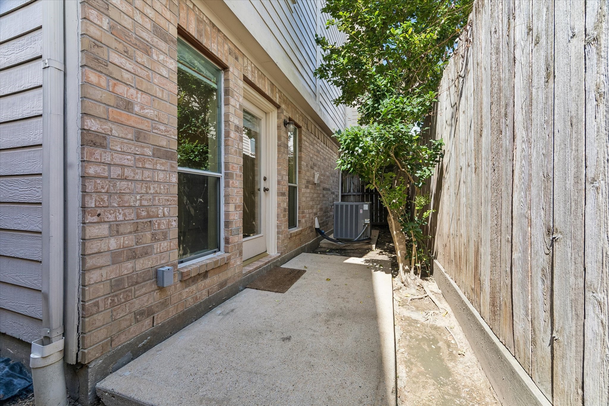 2915 Jackson Street Houston, TX 77004 - Photo 21 of 23 a view of a brick house with potted plants in front of door