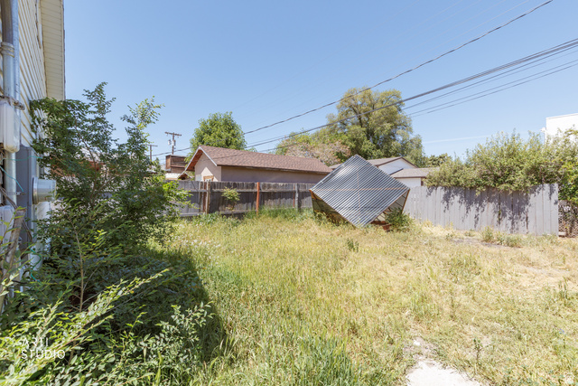 330 West 600th Street South Provo, UT 84601 - Photo 23 of 26 Expansive rear yard featuring natural landscaping and a wood fence perimeter