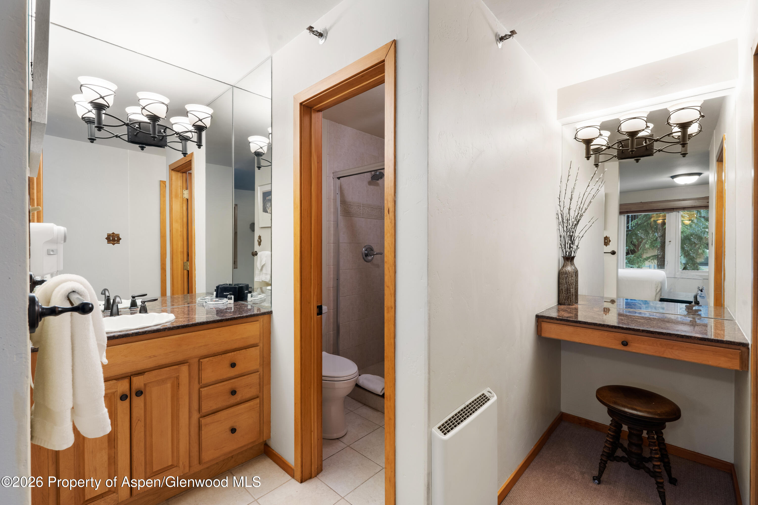 400 Wood Road, Unit 2111H Snowmass Village, CO 81615 - Photo 8 of 16 a bathroom with a sink vanity and mirror
