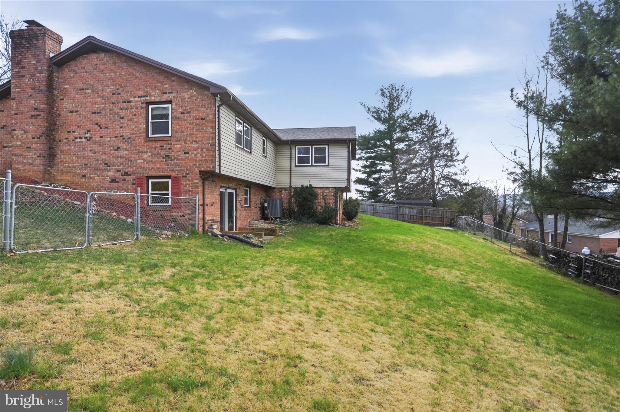 20 Gloucester Road Front Royal, VA 22630 - Photo 40 of 43 a view of a brick house with a big yard and large trees