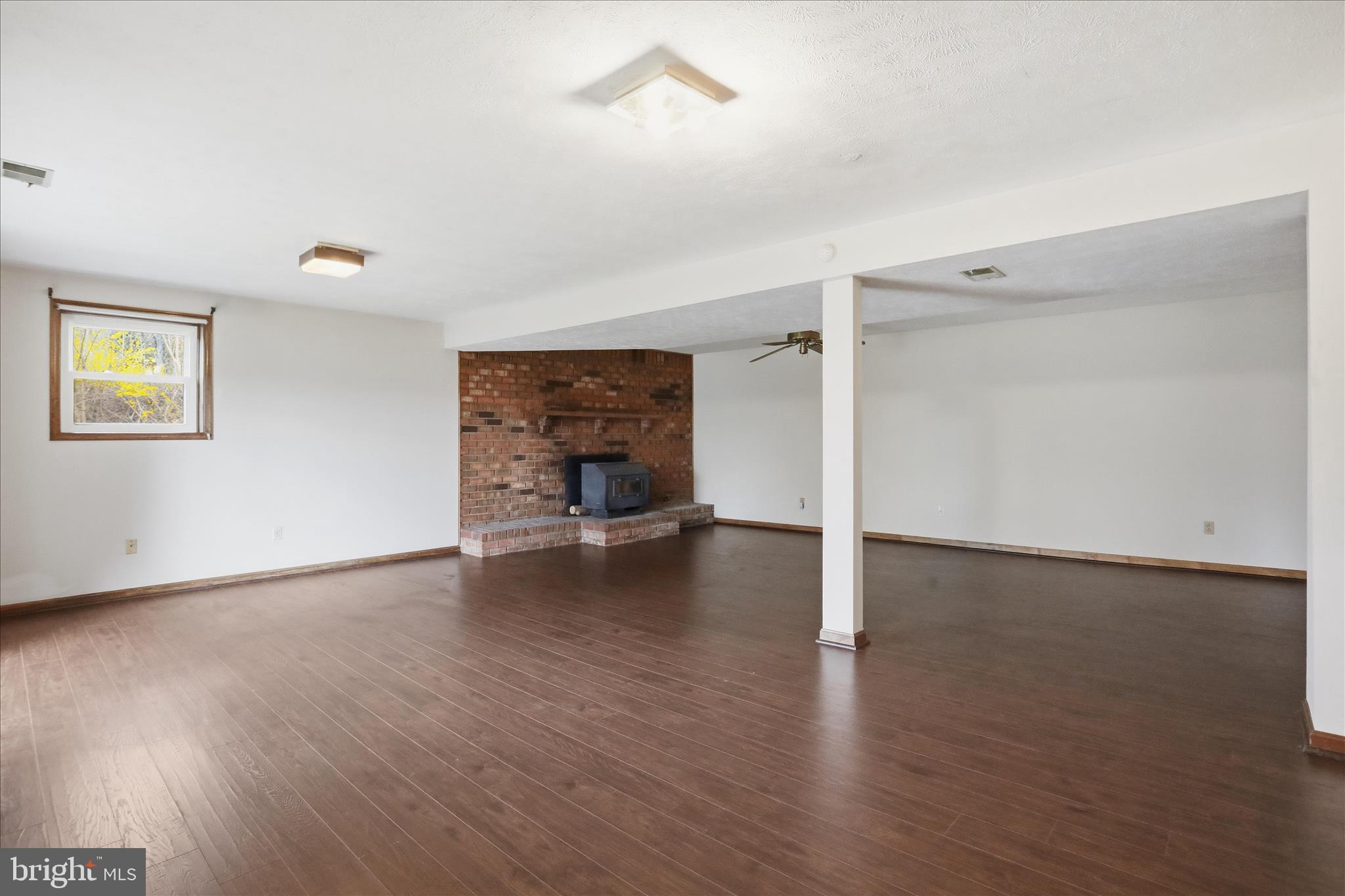 20 Gloucester Road Front Royal, VA 22630 - Photo 5 of 43 an empty room with wooden floor fireplace and windows