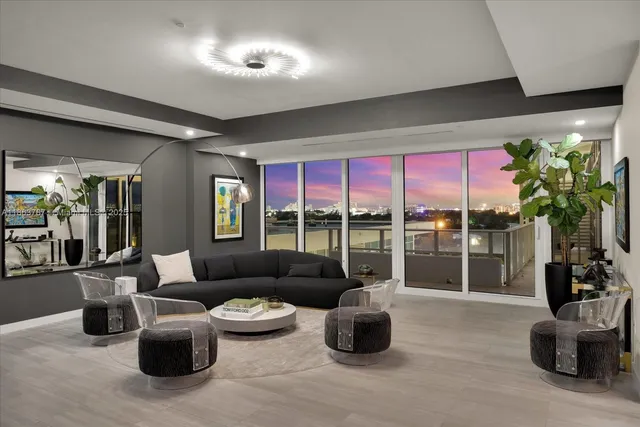 a living room with furniture a lamp and a potted plant