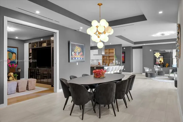 a view of a dining room with furniture and chandelier