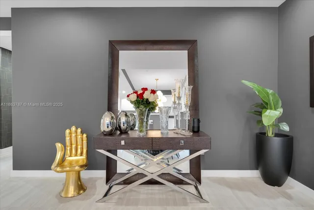 a dining room with furniture and a potted plant