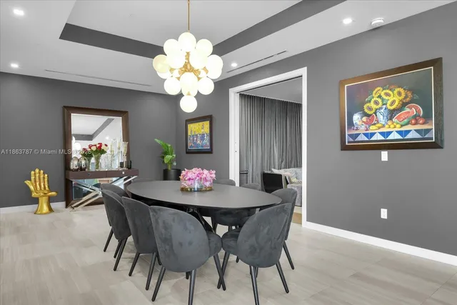 a dining room with furniture and chandelier