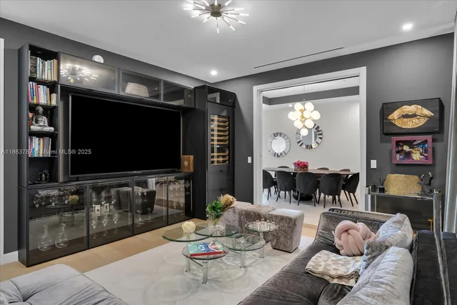 a bedroom with bed and a chandelier