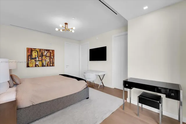 a spacious bedroom with a bed and a couch