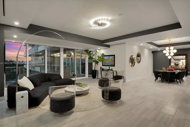 a living room with furniture and a chandelier