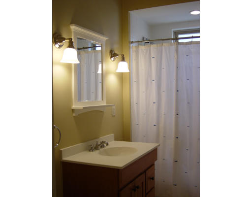 185 Rawson Road, Unit 3 Brookline, MA 02445 - Photo 12 of 18 a bathroom with a sink a mirror and a shower