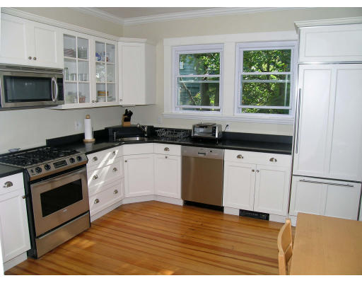 185 Rawson Road, Unit 3 Brookline, MA 02445 - Photo 2 of 18 a kitchen with granite countertop a stove a sink and a microwave