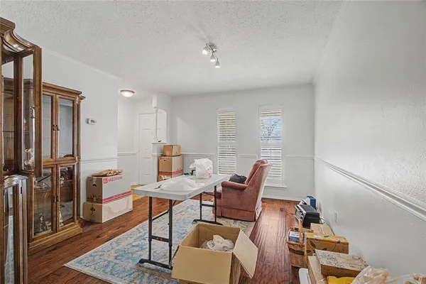 a living room with furniture a rug and white walls
