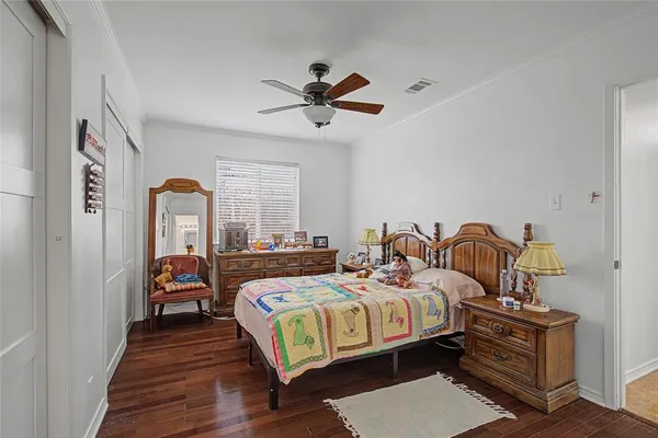 a bedroom with bed and a chandelier