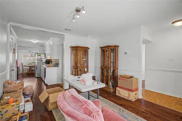a living room with furniture and wooden floor