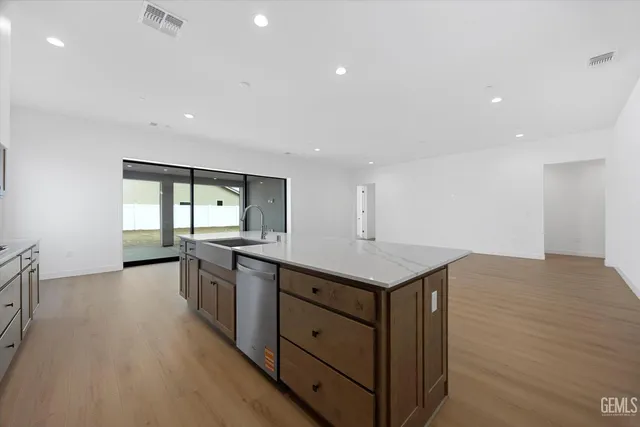 a kitchen with a stove a sink and a refrigerator
