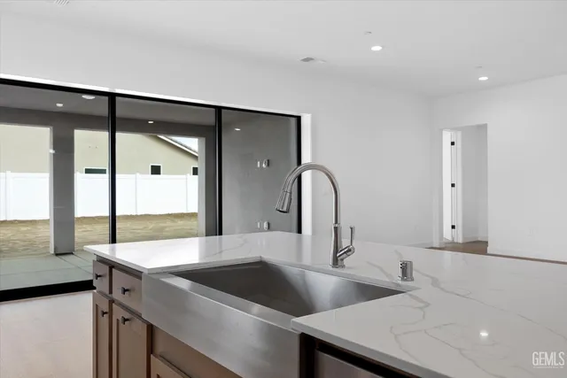 a kitchen with a sink and a refrigerator