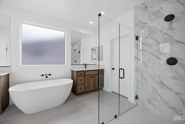a spacious bathroom with a double vanity sink double mirror and bathtub