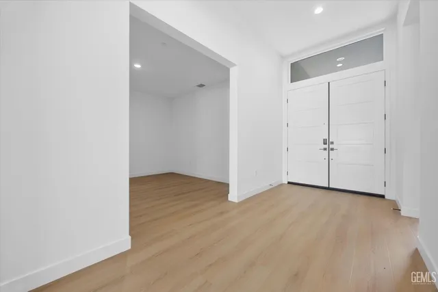a view of an empty room with wooden floor
