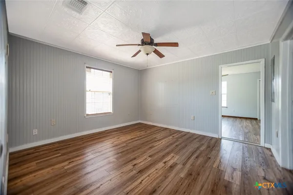 a view of an empty room and wooden floor