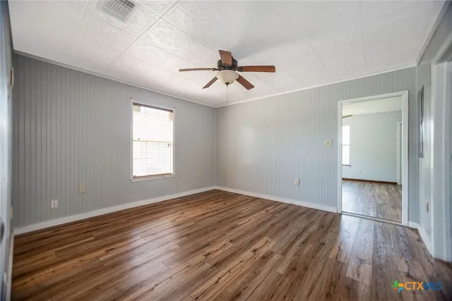 a view of an empty room and wooden floor